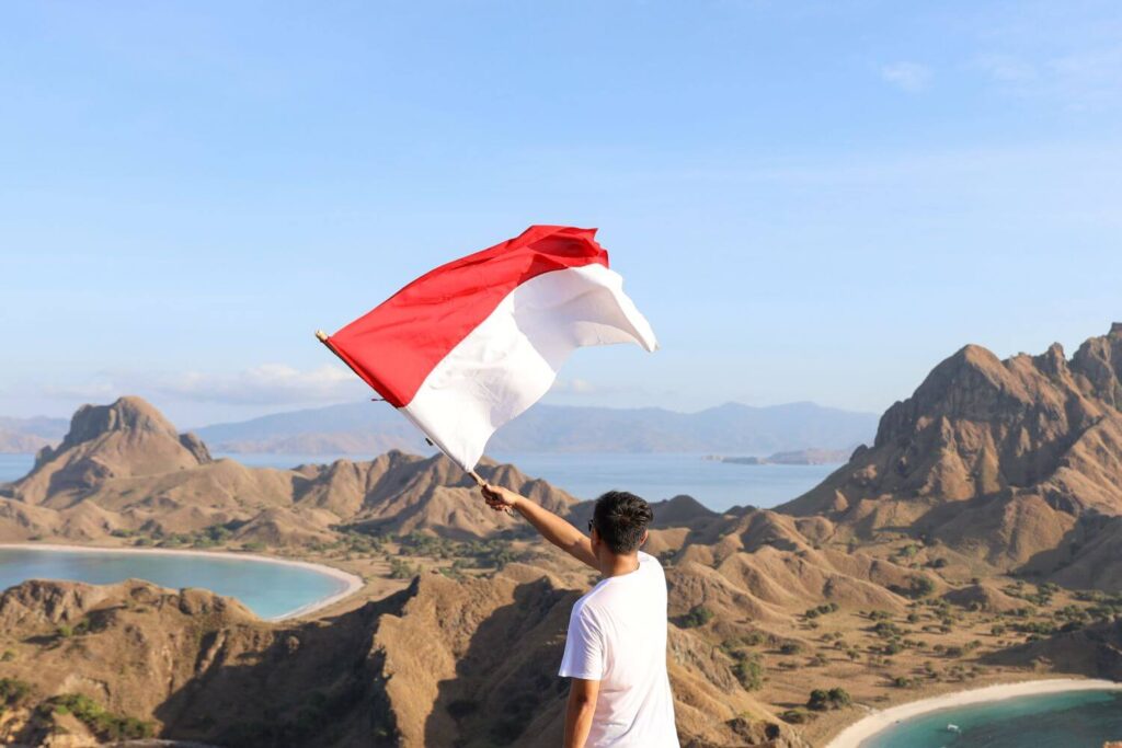 back-side-a-man-holding-and-waving-indonesian-flag
